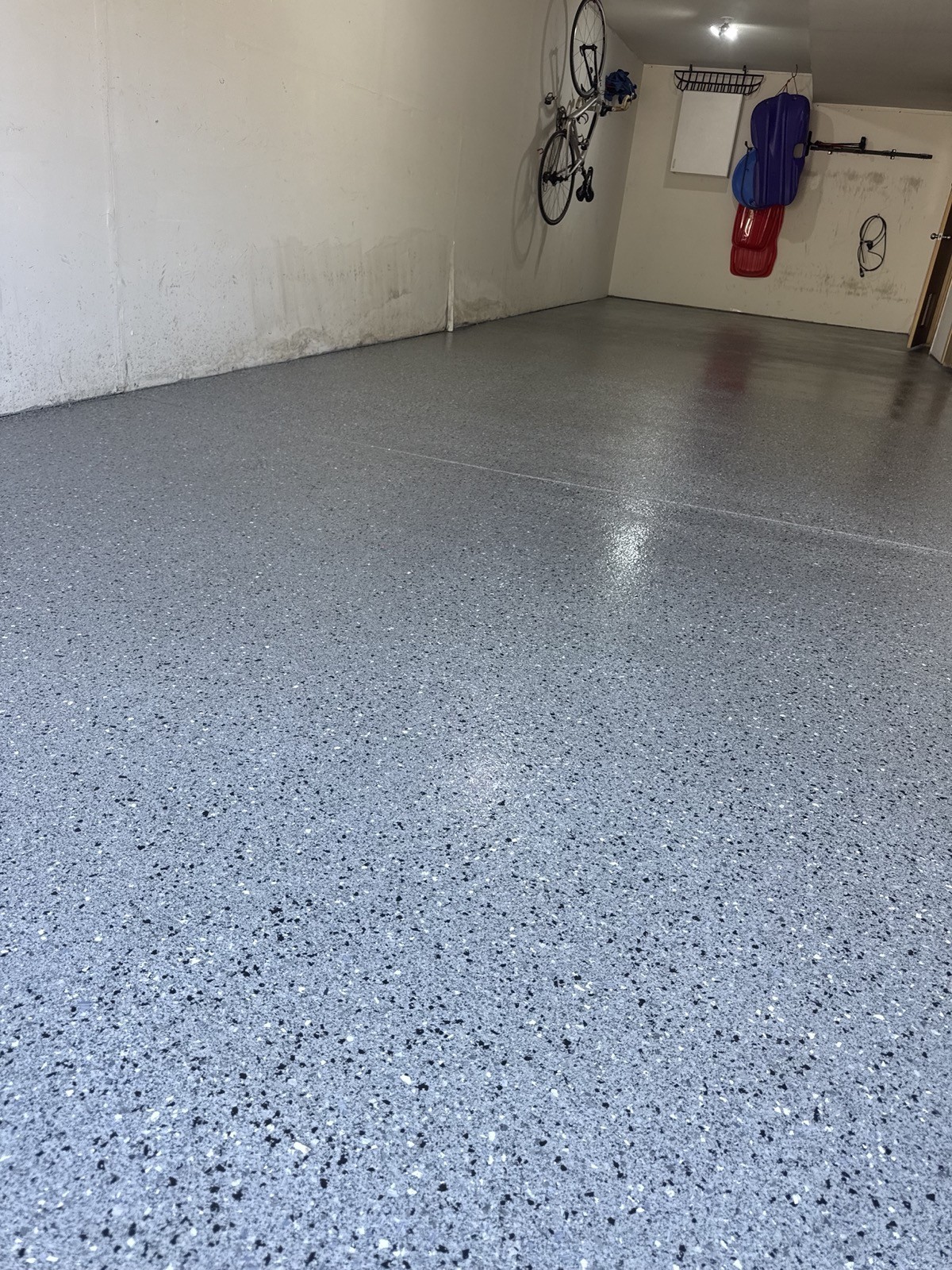 After — grey epoxy flake garage floor in a Frisco CO mountain home garage